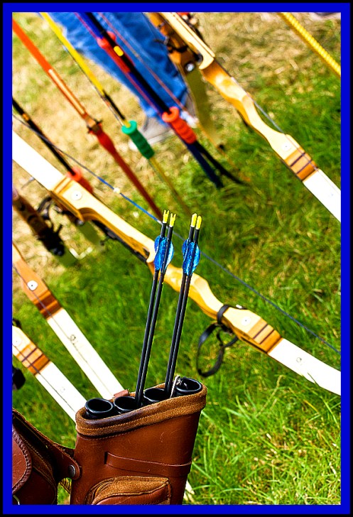 Archery equipment shot at an angle. Bows, arrows, and quiver.